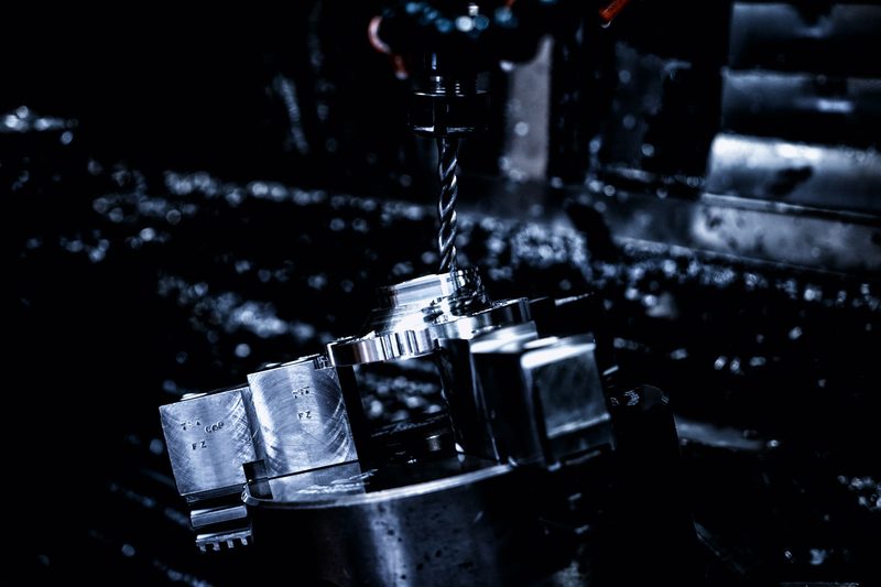 IAMETECH, the workshop — A drill bit at work, among the chips.