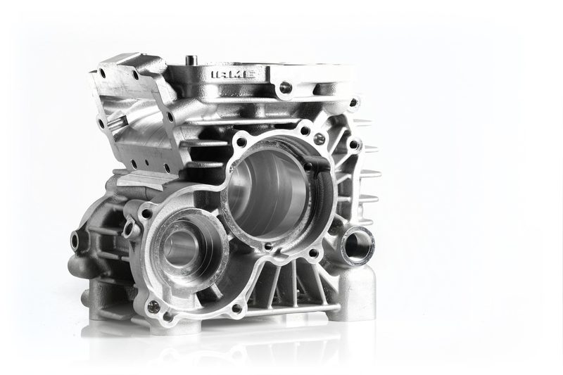 IAMETECH, product still life — An engine crankcase, with the IAME logo in relief.